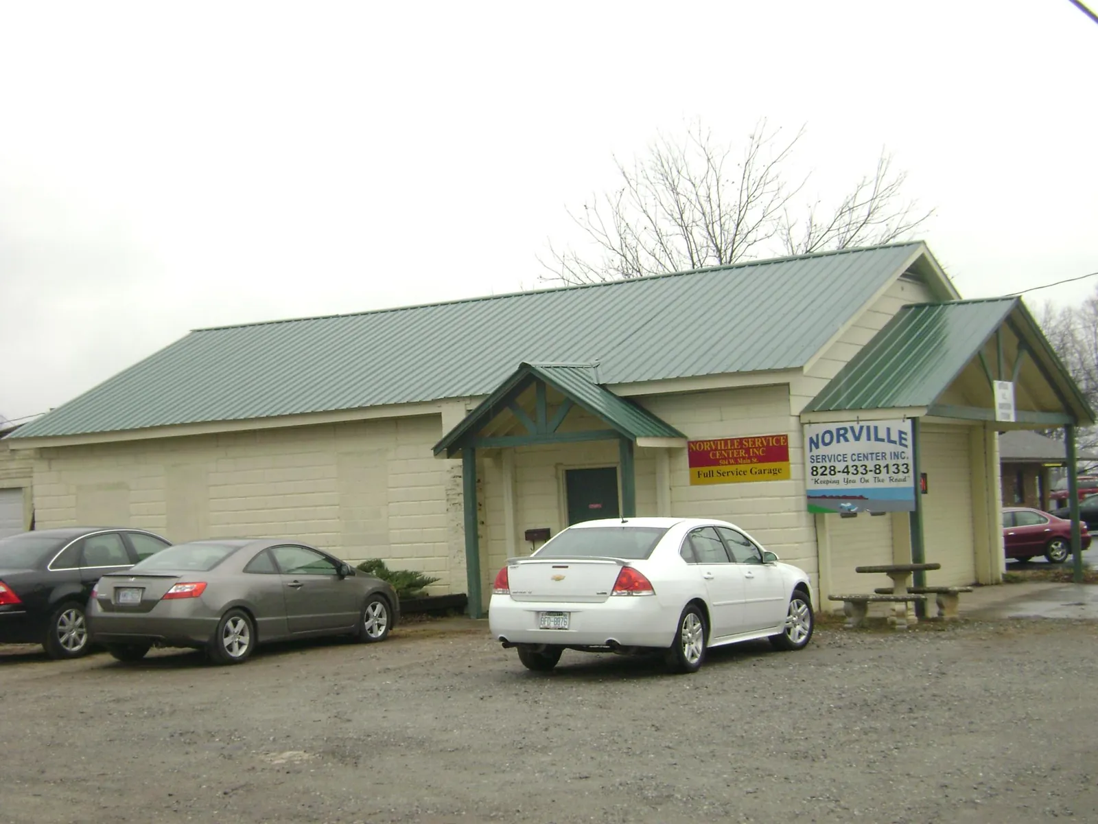 Green metal roof on a service garage with a covered entry in Franklin